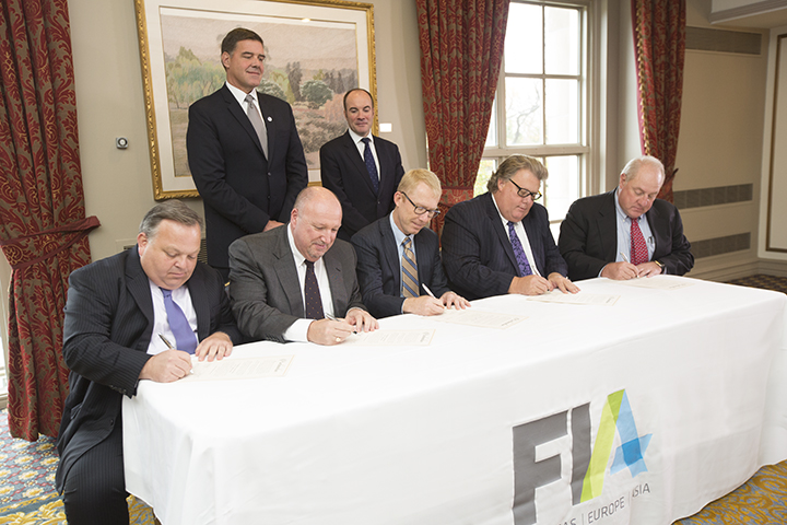 Representatives from FIA affiliates sign official documents to merge into a single organization