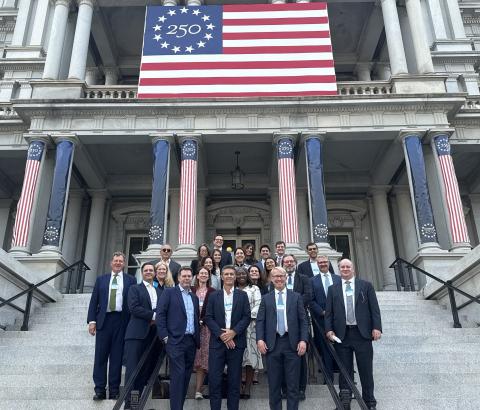 FIA board members and staff standing on the steps of the Eisenhower Executive Office Building while meeting with policymakers during the US fly-in.