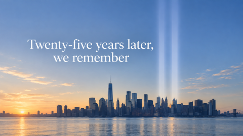 An image of the New York City skyline at sunset, with beams of light representing the World Trade Center towers.
